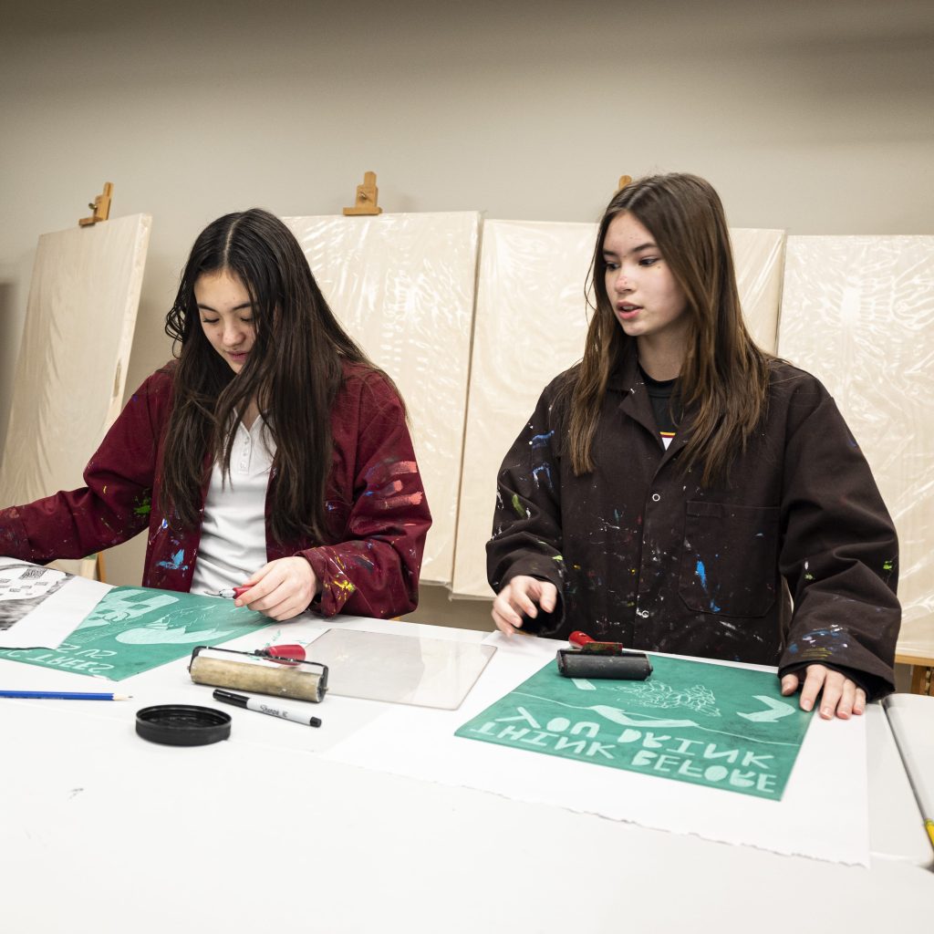 Photograph of two students working on an art project