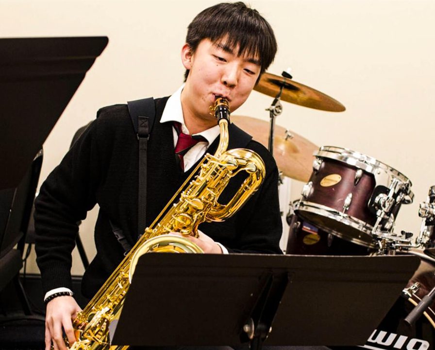 A Senior School student playing the saxophone